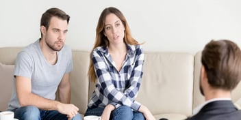 Man and woman talk to a divorce lawyer 