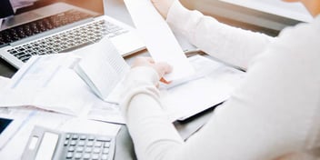 person at desk completing financial paperwork