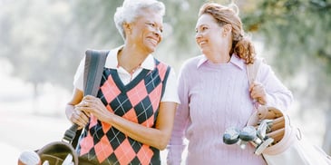 women playing golf together