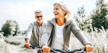 happy man and woman riding bikes on a trail