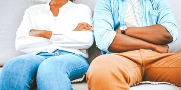 couple with both arms crossed and sitting.