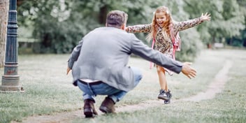 young girl running to her father