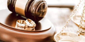 two wedding bands and a gavel