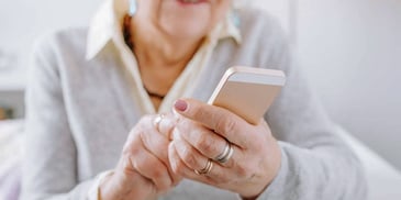 elderly woman holding phone