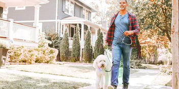 middle age man walking dog 