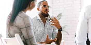 man articulating his feelings to a therapist