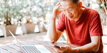 man concentrating on calculator