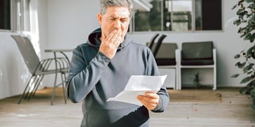 man reading paperwork