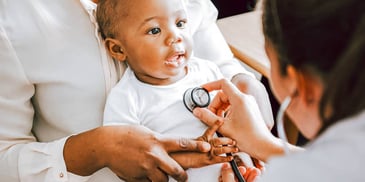 infant Black girl getting a medical checkup