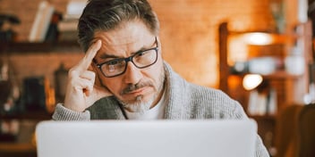 man thinking about something he's reading online