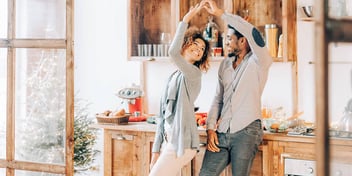 domestic partners man and woman dancing in their home