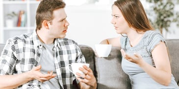 young couple drinking tea and arguing