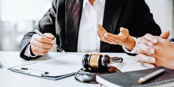 two people meeting at a desk in a legal office