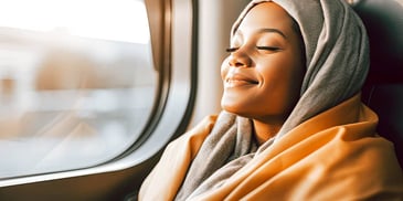 happy relaxed woman riding home on a train