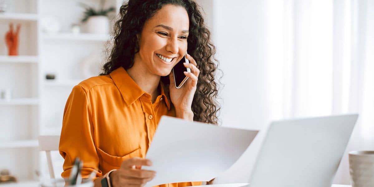 happy-woman-paperwork-phonecall