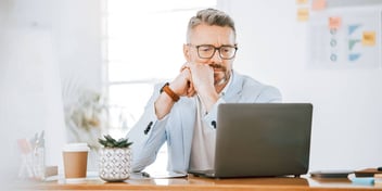 man considering his next move in a cafe or office setting