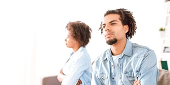 couple sitting apart and ignoring each other