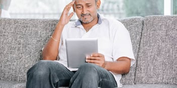 man reading on his tablet as he prepares for divorce