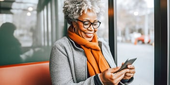 smiling woman looking up something on her phone