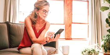 woman scrolling through social media on her phone