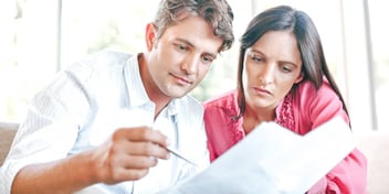 man and woman reviewing a postnuptial agreement