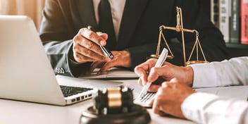 judge going over legal papers with someone