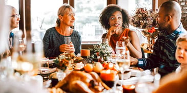 family and friends having Thanksgiving dinner