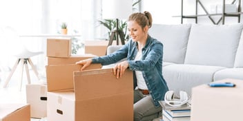 woman opening moving boxes full of memories