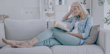 A Newly Divorce Woman Reading a Book to Help Her Through Divorce