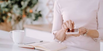 woman planning her divorce with a notebook and phone